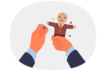 Voodoo doll in hands of business man who uses black magic and pagan curses for unfair competition. Vindictive guy pierces voodoo doll with needles, wanting to make enemy or competitor suffer