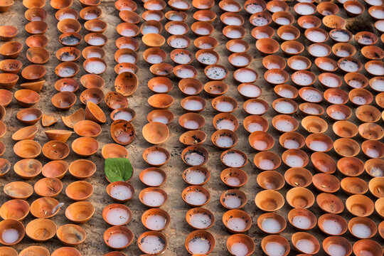 Rows of Small Terracotta Bowls Filled with Oil Line the Shore of the Ganges River in Varanasi India