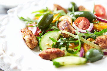 Healthy Salad with Chicken Breast, Cherry Tomatoes, Cucumber, Rocket and Green Olives. Close up.	