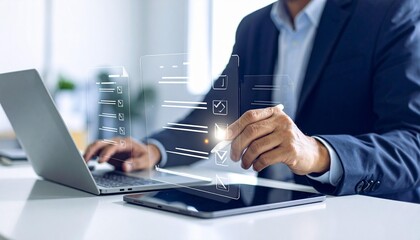 Fototapeta premium Business person completing digital checklist with pen on tablet near laptop and phone