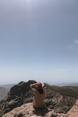Woman Enjoying Scenic View on Mountain Summit