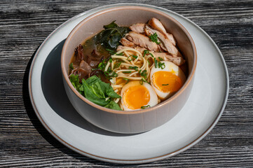 Ramen soup in cafe on wooden table. 