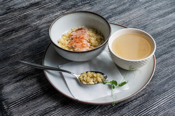 Chicken broth with noodles on a wooden table. 