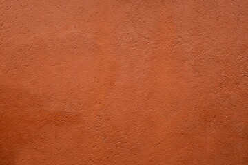 Russet-toned textured surface, possibly leather or plaster.