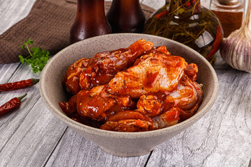 Raw marinated buffalo chicken wings