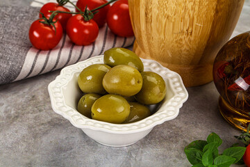 Big green marinated olives in the bowl