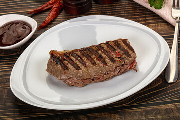 Grilled beef striploin steak with sauce