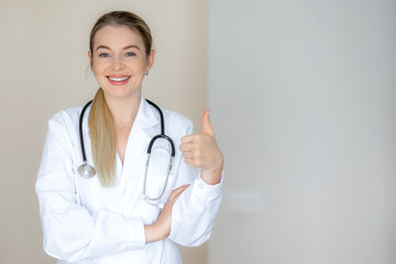 Smiling doctor giving thumbs-up with a confident expression in clinic setting