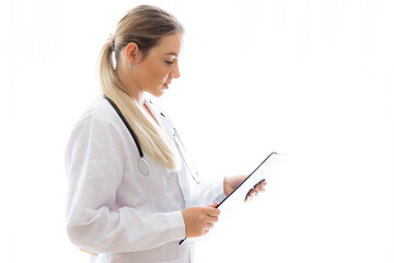 Female doctor reviewing medical notes with clipboard in a bright setting