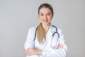 Smiling female doctor standing with confidence in a white lab coat