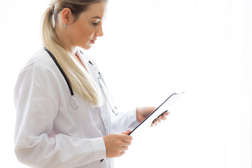 Female doctor reviewing a medical clipboard in a professional setting