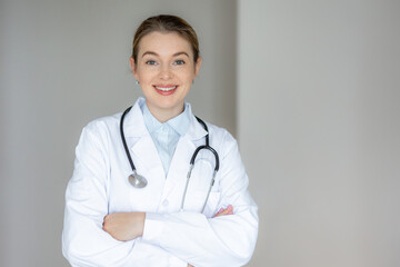 Smiling female doctor in a white coat with a stethoscope