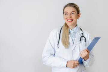 Smiling female doctor holding a clipboard and wearing a stethoscope in casual attire