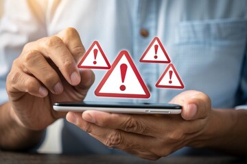 Warning signs appearing above smartphone held by person