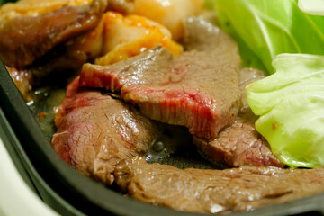 Beef grilled on a hot plate, the name of the dish is “yakiniku.”