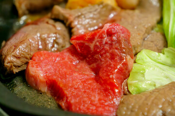 Beef grilled on a hot plate, the name of the dish is “yakiniku.”
