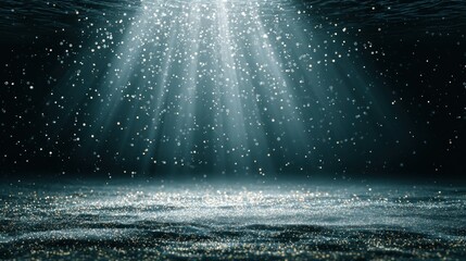 Underwater scene with light beams and glittering particles.