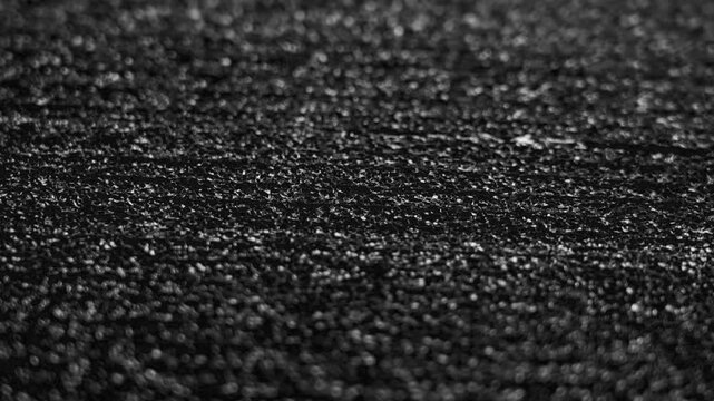 Black foam layered textured soft material. Macro shot