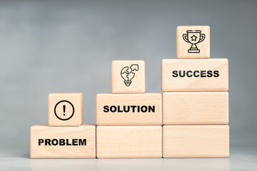 Wooden blocks stacked in steps labeled problem, solution, and success, symbolizing growth,...