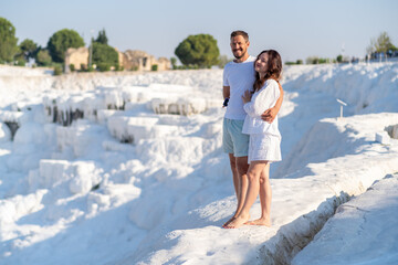 Couple Enjoying a Romantic Moment at Pamukkales White Terraces Under a Clear Blue Sky