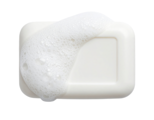 A white bar of soap partially covered with white foam bubbles.