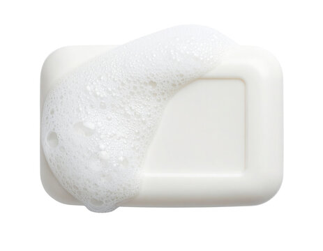 A white bar of soap partially covered with white foam bubbles.