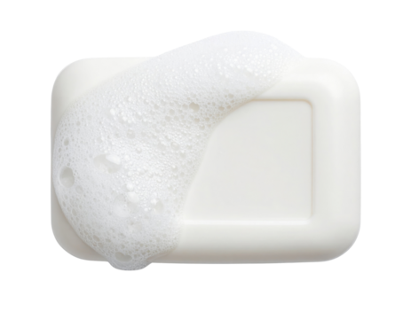 A white bar of soap partially covered with white foam bubbles.