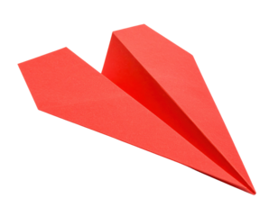 A red paper airplane with sharp folds and a pointed nose, shown from a slightly elevated angle.