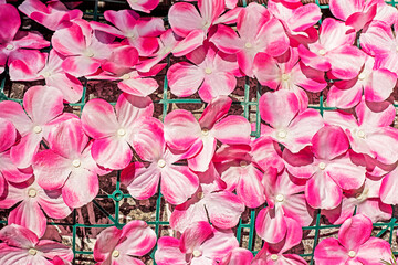 background of decorative pink flowers attached to the outside mesh