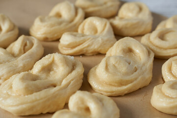 Raw buns on a baking sheet, close-up, horizontal
