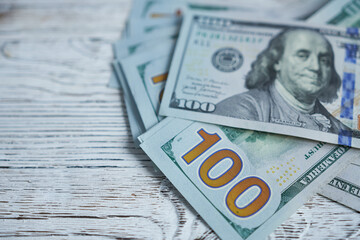 American dollars banknotes on a wooden background. Selective focus.