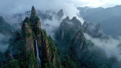 Misty mountain peaks, dramatic waterfall cascading down a sheer cliff face