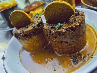 Traditional Scottish haggis served with rich gravy. A classic dish of Scottish cuisine, often enjoyed in Edinburgh. Concept of authentic local food and cultural heritage in the UK