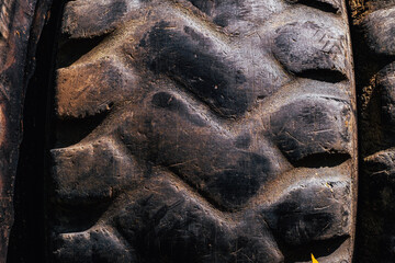 Used Grader Wheel with Dirt and Rust, The image captures the rough, rugged texture of the rubber, emphasizing the wear and tear © Roberto Sorin