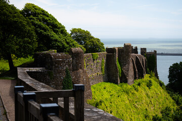 Medieval English landscape near the stone walls of Dover Castle with the sea in the background....