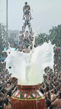 Dahi Handi celebration with human pyramid, colorful crowd cheering, rain falling, high-speed camera capture of the moment the pot breaks &mdash; high graphics, festival vibe