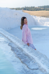 Visitor Enjoying the Stunning Travertine Terraces of Pamukkale During a Sunny Day in Turkey