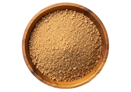 Rustic wooden bowl filled with light brown granulated sugar overhead image