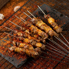 Grilled lamb skewers sprinkled with chili powder and skewered with iron sticks