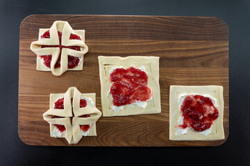 Pastry with raspberry jam from puff pastry. Dessert from dough. Delicious and high-calorie food