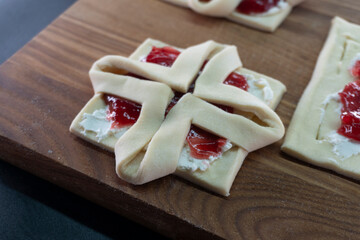 Pastry with raspberry jam from puff pastry. Dessert from dough. Delicious and high-calorie food