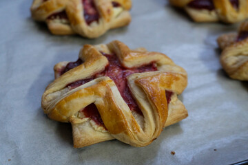 Pastry with raspberry jam from puff pastry. Dessert from dough. Delicious and high-calorie food