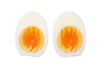 Two perfectly halved hard boiled eggs with bright orange yolks on image