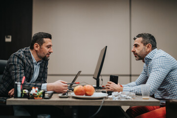 Colleagues engaged in a thoughtful business conversation in a modern office setting, emphasizing...