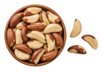 Wooden bowl filled with Brazil nuts scattered on food
