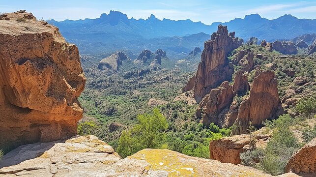 Desert vista from a rocky overlook.  Vast landscape of red rocks, valley, and mountains - Powered by Adobe