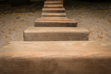 Wooden path leads through serene sandy landscape inviting exploration and connection with nature's...