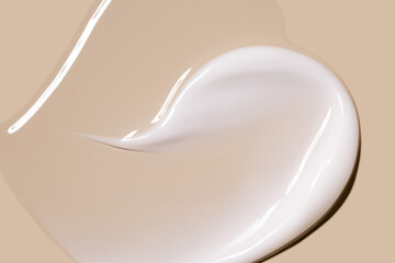 creamy texture of cosmetic samples on a pastel beige background
