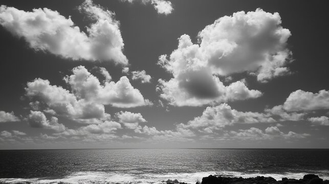 Black and white seascape with dramatic clouds - Powered by Adobe