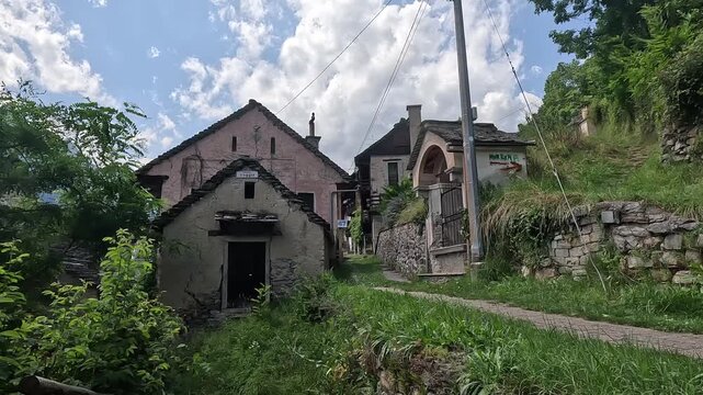 Historic Stone Houses and Chapel in the Mountain Village of Varzo, Piedmont, Italy on a Sunny Day